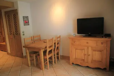 a living room with a red couch and a table at At Home in Les Carroz d'Araches