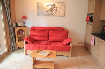 a kitchen with wooden cabinets and a counter top at At Home in Les Carroz d'Araches