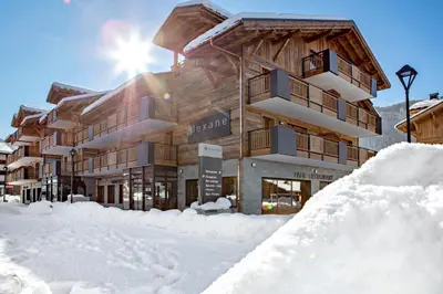 a ski lodge in the snow with a pile of snow at MGM Hôtels & Résidences - Hôtel Les Suites d'Alexane in Samoëns