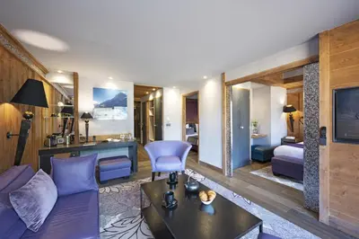 a living room with a couch and a table at MGM Hôtels & Résidences - Hôtel Les Suites d'Alexane in Samoëns