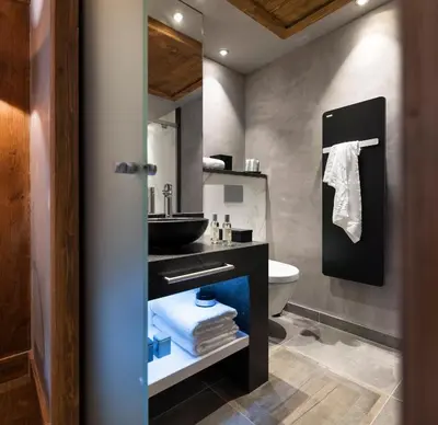 a bathroom with a sink and a toilet at MGM Hôtels & Résidences - Hôtel Les Suites d'Alexane in Samoëns