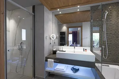 a bathroom with a sink and a shower at MGM Hôtels & Résidences - Hôtel Les Suites d'Alexane in Samoëns