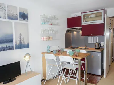 a dining room table with blue dishes on it at Studio Le Sapin by Interhome in Demi-Quartier
