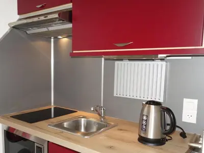 a room with two bunk beds and a mirror at Studio Le Sapin by Interhome in Demi-Quartier