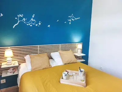 a bedroom with a large bed with a yellow bedspread at Apartment Crespin by Interhome in Saint-Gervais-les-Bains