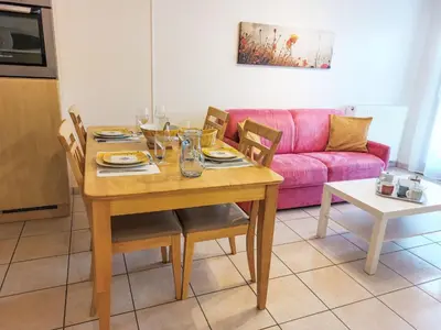 a wooden table with yellow plates and glasses on it at Apartment Crespin by Interhome in Saint-Gervais-les-Bains
