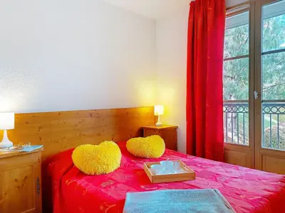 a bed with two furry pillows and a box on it at Apartment Les erables by Interhome in Saint-Gervais-les-Bains