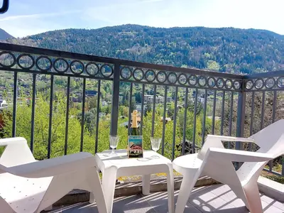 a living room with a red couch and a table at Apartment Les erables by Interhome in Saint-Gervais-les-Bains