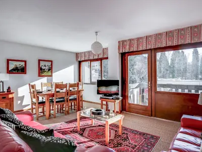 a living room with two red couches and a table at Apartment Fleurs des Alpes-1 by Interhome in Saint-Gervais-les-Bains