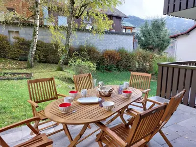 a living room with a couch and a table with wine glasses at Apartment Le Sporting-1 by Interhome in Saint-Gervais-les-Bains