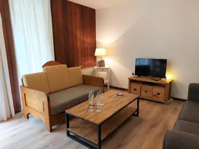 a dining room table with plates and dishes on it at Apartment Le Sporting-1 by Interhome in Saint-Gervais-les-Bains