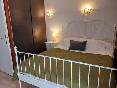 a bedroom with a bed with two night stands and two lights at Apartment Le Sporting-1 by Interhome in Saint-Gervais-les-Bains