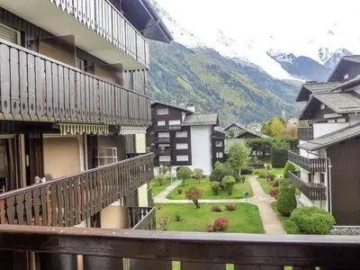 a large building in front of a mountain at Apartment Clos du Savoy-23 by Interhome in Chamonix-Mont-Blanc