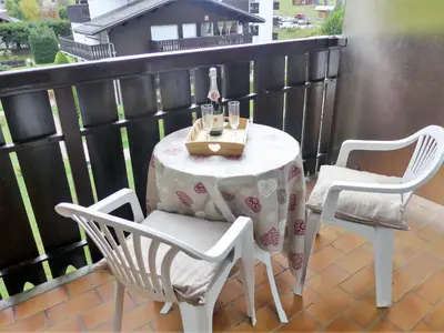 a table and two chairs on a balcony with a table at Apartment Clos du Savoy-23 by Interhome in Chamonix-Mont-Blanc