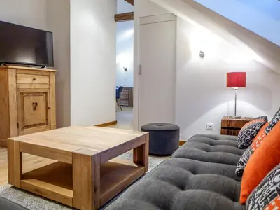 a living room with a couch and a coffee table at Apartment Le Chalet Suisse-3 by Interhome in Chamonix-Mont-Blanc