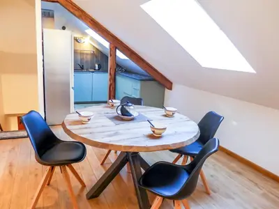 a dining room with a wooden table and chairs at Apartment Le Chalet Suisse-3 by Interhome in Chamonix-Mont-Blanc