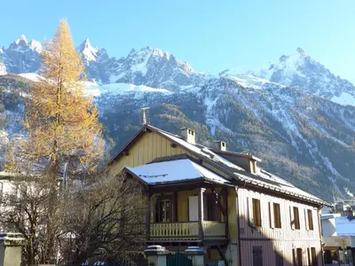 a house with a snow covered mountain in the background at Apartment Le Chalet Suisse-3 by Interhome in Chamonix-Mont-Blanc