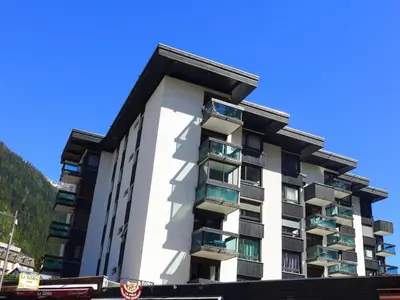 a tall white building with balconies on a street at Studio L'Aiguille du Midi-7 by Interhome in Chamonix-Mont-Blanc