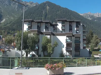 a large apartment building in front of a mountain at Studio L'Aiguille du Midi-7 by Interhome in Chamonix-Mont-Blanc
