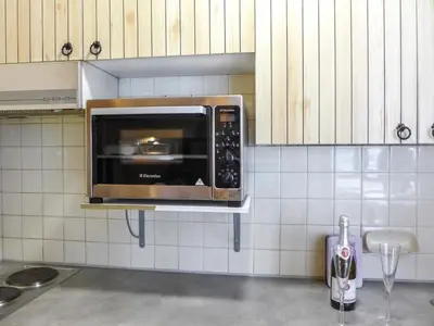 a microwave oven on a wall in a kitchen at Studio L'Aiguille du Midi-7 by Interhome in Chamonix-Mont-Blanc