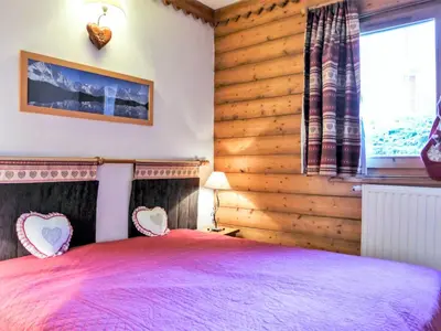 a bedroom with a bed with a wooden wall at Apartment Ginabelle 1-1 by Interhome in Chamonix-Mont-Blanc
