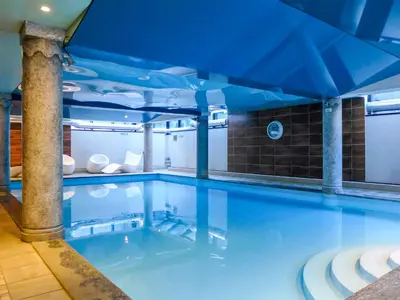 a large swimming pool with a blue ceiling at Apartment Ginabelle 1-1 by Interhome in Chamonix-Mont-Blanc