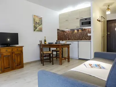 a small living room with a table and a kitchen at Studio Le Pramouny-2 by Interhome in Chamonix-Mont-Blanc