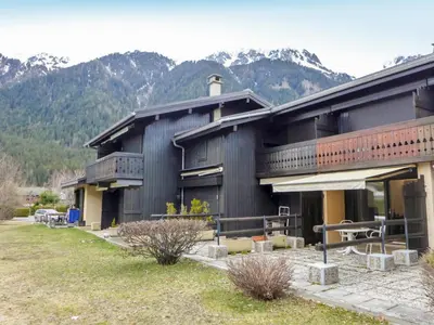 a large building with mountains in the background at Studio Le Pramouny-2 by Interhome in Chamonix-Mont-Blanc