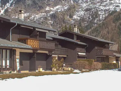 a house with snow in front of a mountain at Studio Le Pramouny-2 by Interhome in Chamonix-Mont-Blanc