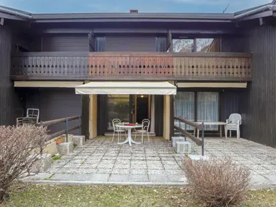 a patio with a table and chairs and a balcony at Studio Le Pramouny-2 by Interhome in Chamonix-Mont-Blanc