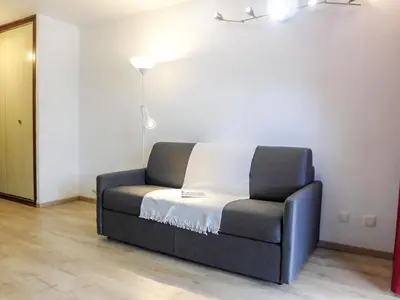 a couch sitting in a living room with a lamp at Studio Le Pramouny-2 by Interhome in Chamonix-Mont-Blanc