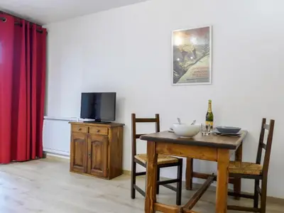 a dining room with a table and a tv at Studio Le Pramouny-2 by Interhome in Chamonix-Mont-Blanc