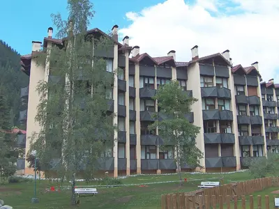a large building with benches in front of it at Apartment Grand Roc-4 by Interhome in Chamonix-Mont-Blanc