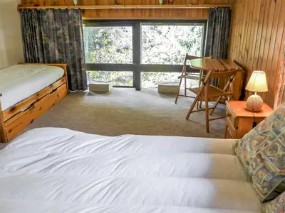 a bedroom with a bed and a desk and a window at Apartment Grand Roc-4 by Interhome in Chamonix-Mont-Blanc