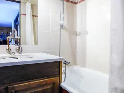 a bathroom with a sink and a bath tub at Apartment Grand Roc-4 by Interhome in Chamonix-Mont-Blanc