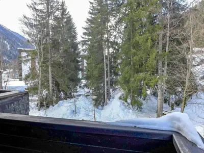 a view of a snow covered yard from a balcony at Apartment Grand Roc-4 by Interhome in Chamonix-Mont-Blanc