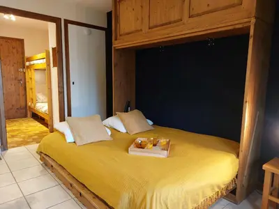 a bedroom with a bed and a table with a dining room at Studio Le Taguy by Interhome in Mémontel