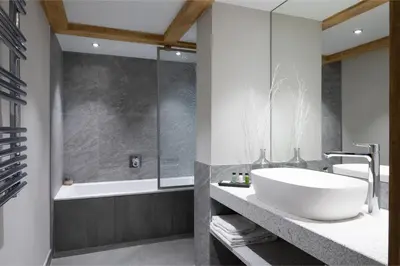 a bathroom with a tub and a sink and a bath tub at MGM Hôtels & Résidences - Résidence Chalets Elena in Les Houches