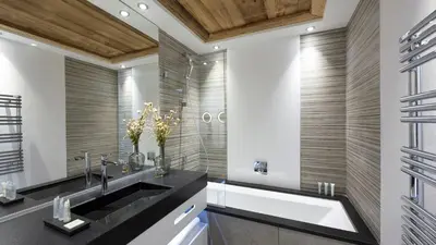 a bathroom with a large sink and a tub at MGM Hôtels & Résidences - Résidence Alexane in Samoëns