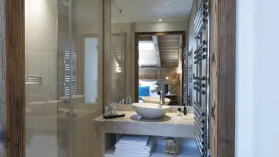 a bathroom with a sink and a mirror at MGM Hôtels & Résidences - Résidence Alexane in Samoëns