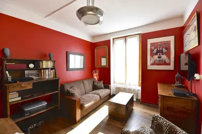 a living room with red walls and a couch at DIFY Cosy - Chamonix in Chamonix-Mont-Blanc