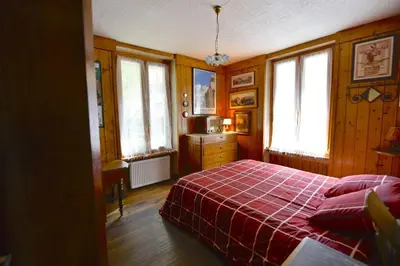 a bedroom with a bed with a red blanket at DIFY Cosy - Chamonix in Chamonix-Mont-Blanc