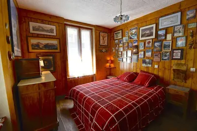 a bedroom with a red bed and pictures on the wall at DIFY Cosy - Chamonix in Chamonix-Mont-Blanc