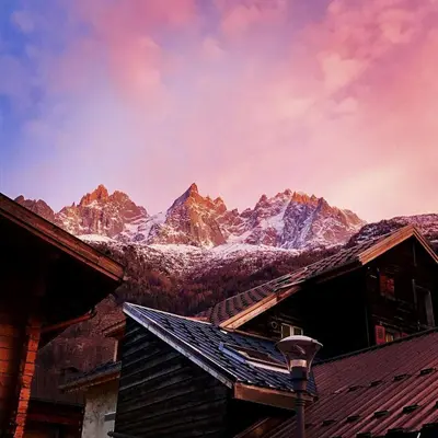a view of a snow covered mountain range with buildings at DIFY Cosy - Chamonix in Chamonix-Mont-Blanc