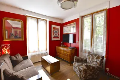 a living room with red walls and a couch and chairs at DIFY Cosy - Chamonix in Chamonix-Mont-Blanc
