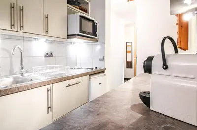 a white kitchen with a sink and a microwave at Spacious Apartment Iris, Flaine Foret in Flaine
