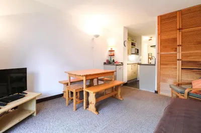 a living room with a table and a kitchen at Spacious Apartment Iris, Flaine Foret in Flaine