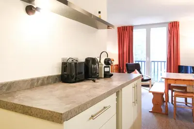 a kitchen with a counter top and a dining room at Spacious Apartment Iris, Flaine Foret in Flaine