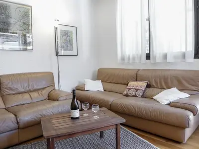 a living room with a couch and a table at Apartment Jonquilles-15 by Interhome in Chamonix-Mont-Blanc