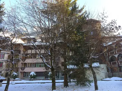 a building with a tree in front of it in the snow at Apartment Jonquilles-15 by Interhome in Chamonix-Mont-Blanc